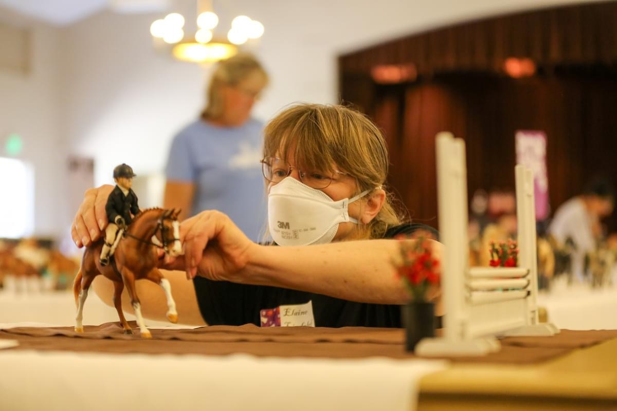 A person sets up a model horse hunter entry